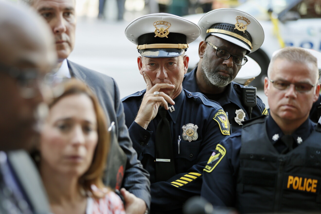 Members of the Cincinnati Police Department listen as Chief Eliot Isaac speaks after a shooting near Fountain Square, Thursday, Sept. 6, 2018, in downtown Cincinnati.